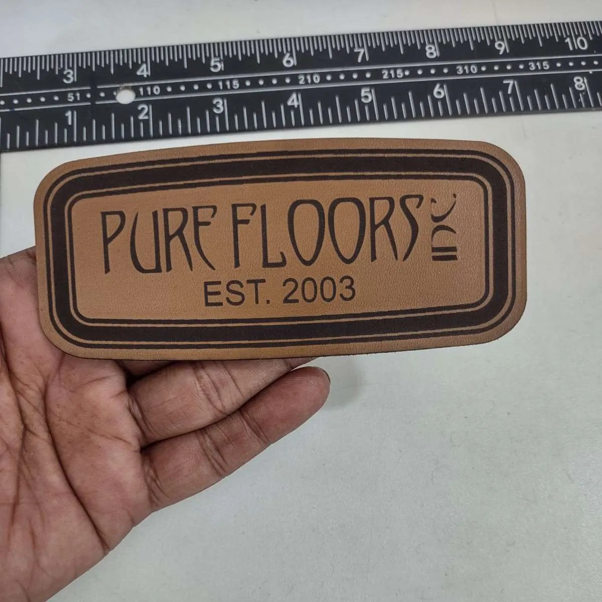 Premium leather patch with embossed logo design - Example 1 by Dynamic Digitizers USA